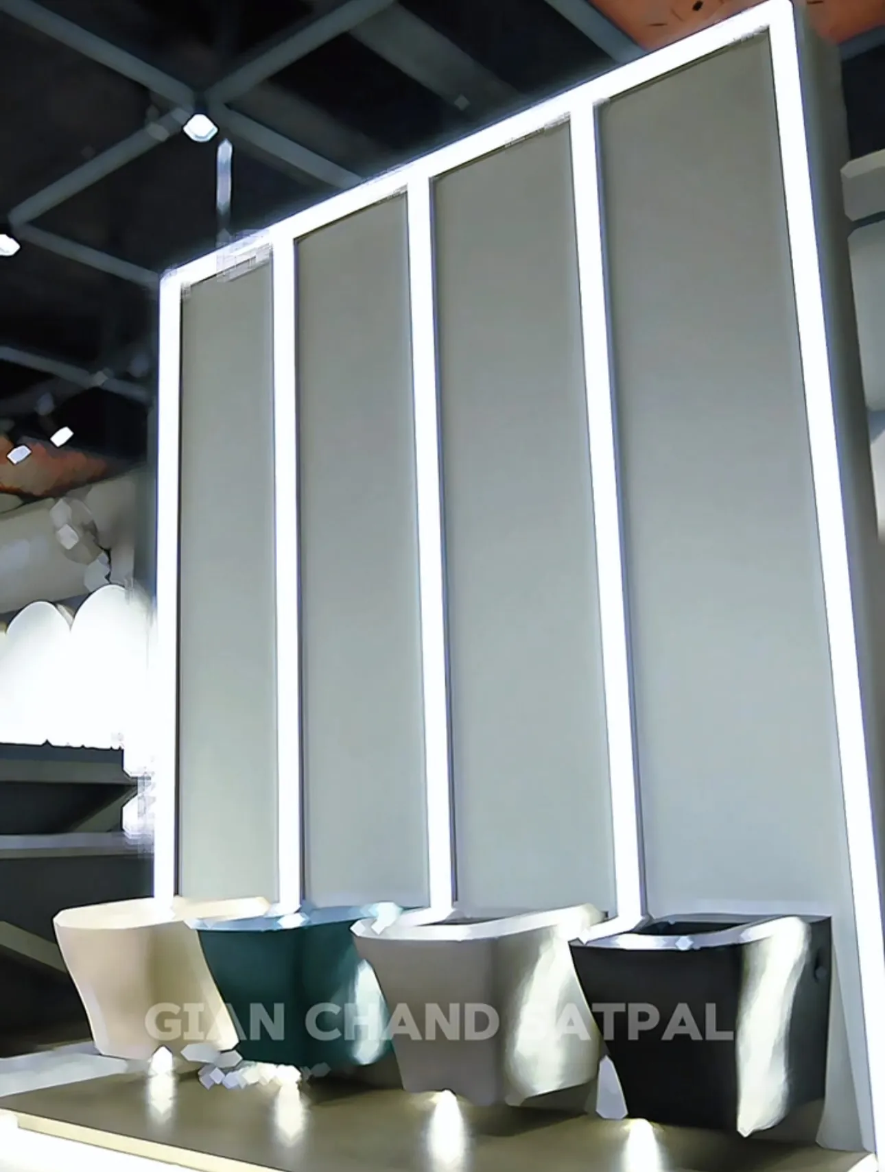 Illuminated display wall with four wall-hung toilets